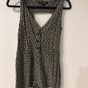 Romper with front buttons and open back. Black with white flowers.